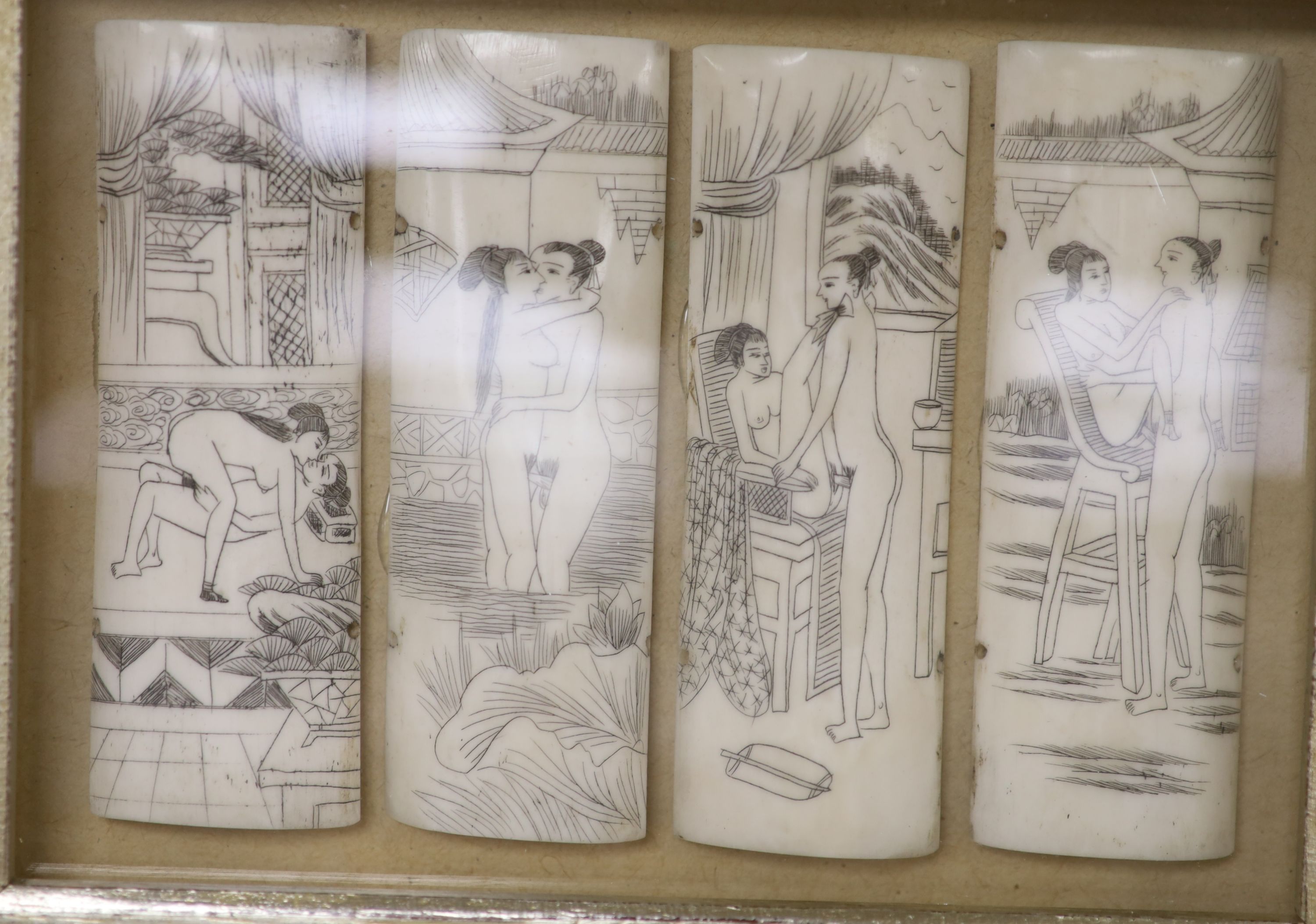 A pair of case framed cut bone panels, decorated with erotic scenes